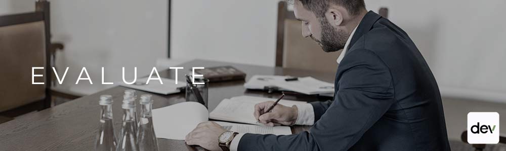 Man at desk evaluating documents - due diligence