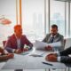 Group of CRE investors at conference table.